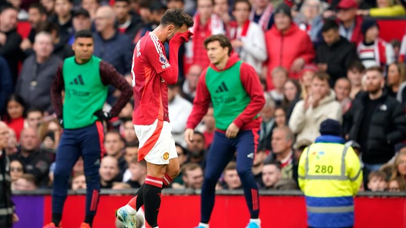 Bruno Fernandes walks off the pitch after getting a red card.