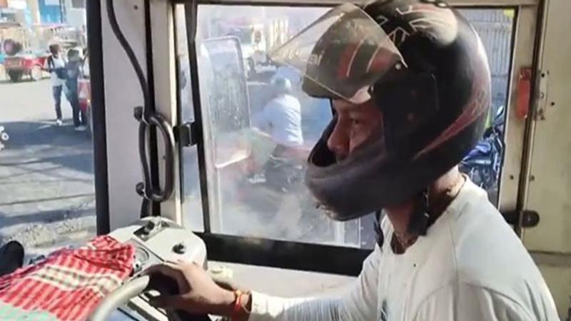 Drivers of North Bengal State Transport Corporation (NBSTC) buses seen wearing helmets