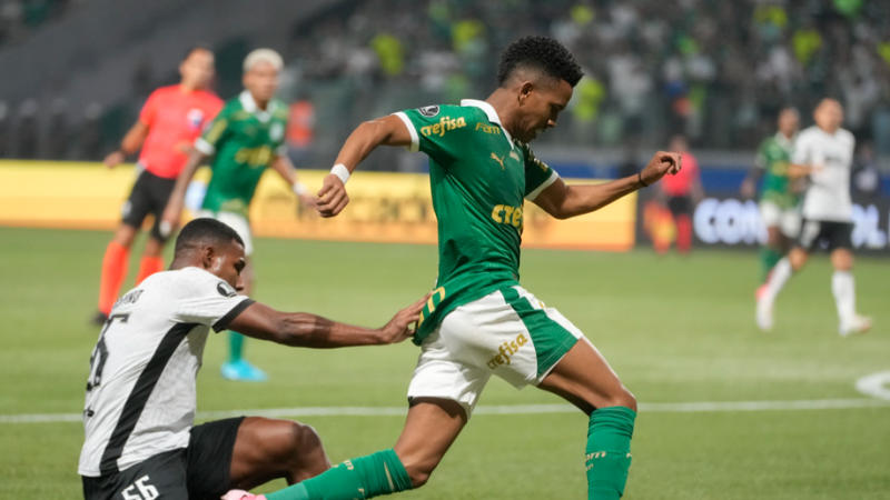 Estevao Willian of Brazil's Palmeiras, right, is challenged by Cuiabano of Brazil's Botafogo during a Copa Libertadores round of 16 second leg soccer match at Allianz Parque stadium in Sao Paulo