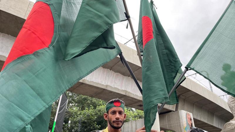 Flag seller Mohd Suman sits at the periphery of the Raju Memorial opposite the Teacher-Student Centre (TSC) of the Dhaka University