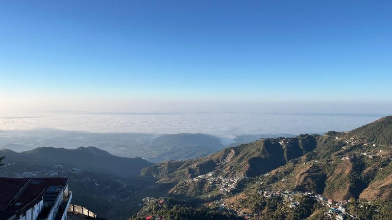 From Brentwood, the winterline in Mussoorie reveals a stunning view—a horizon glowing in warm golden tones, where the sky meets the hills.