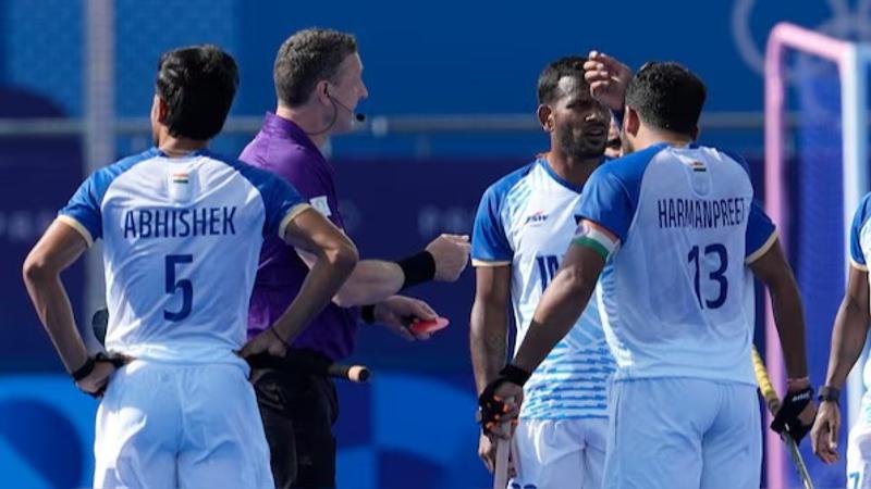 Indian men's hockey team players surround umpires in their quarterfinal at Paris Olympics