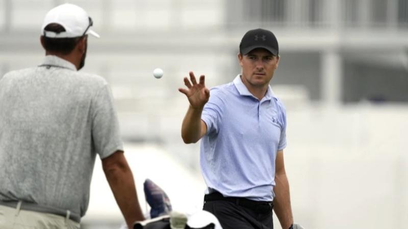 Jordan Spieth, right, catches a ball