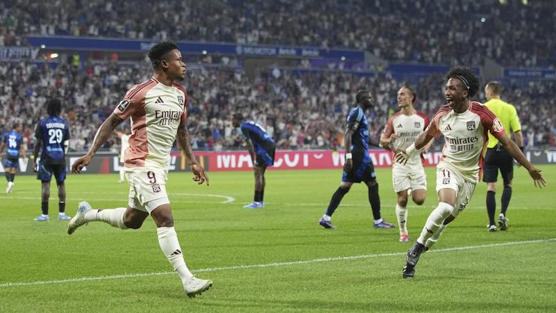 Lyon’s Gift Orban, left, celebrates with Lyon’s Malick Fofana after scoring his side’s fourth goal