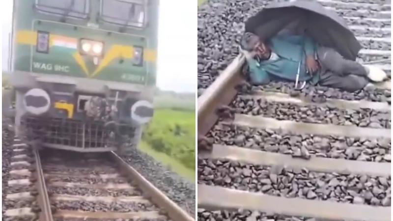 man sleeps on tracks 