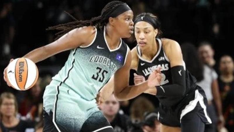 New York Liberty forward Jonquel Jones (35) drives against Las Vegas Aces center A’ja Wilson, right, during the first half of a WNBA basketball game Saturday, Aug. 17, 2024, in Las Vegas.