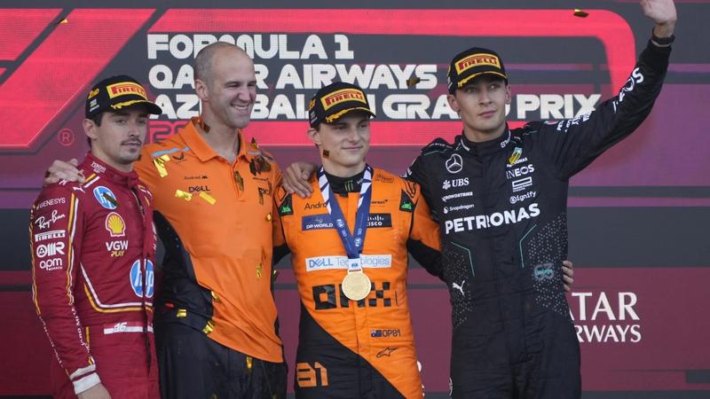 Oscar Piastri celebrates his win as he is surrounded by Charles Leclerc and George Russel.