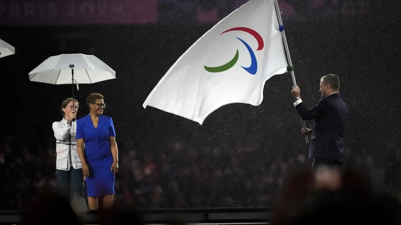 Paralympic Flag being passed to the mayor of Los Angeles.