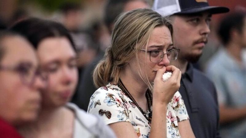 People mourning during the candlelight vigil.