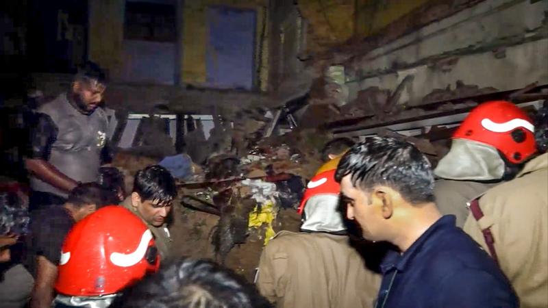 Police personnel and others during a rescue operation at Sabzi Mandi area after a house collapsed following heavy rainfall, in New Delhi,