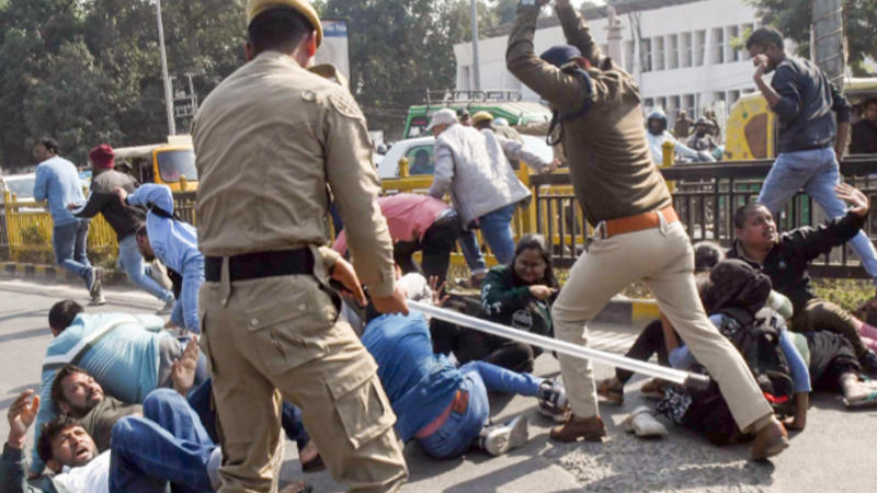 Police personnel baton charge aspirants of 70th BPSC during the protest outside BPSC office over normalization issue in Patna 