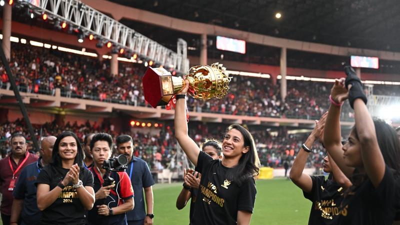 RCB captain Smriti Mandhana celebrates with the WPL trophy