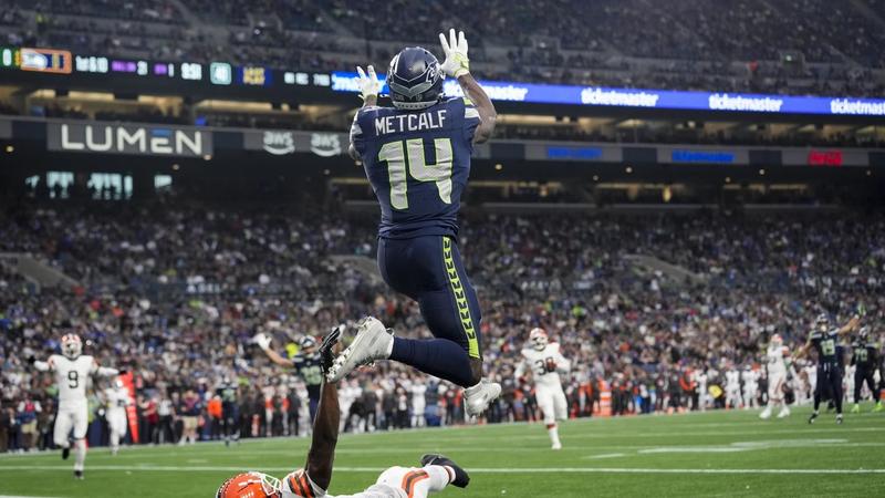 Seattle Seahawks wide receiver DK Metcalf (14) makes a catch for a touchdown over Cleveland Browns cornerback Justin Hardee Sr., bottom, during the first half of a preseason NFL football game