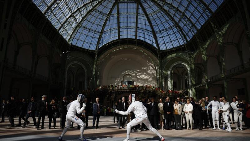 Spectators are admiring the architecture of historic Grand Palace hosting fencing in Paris Olympics