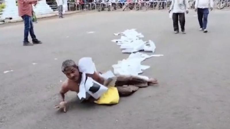 The video captured the man crawling and rolling on the road 