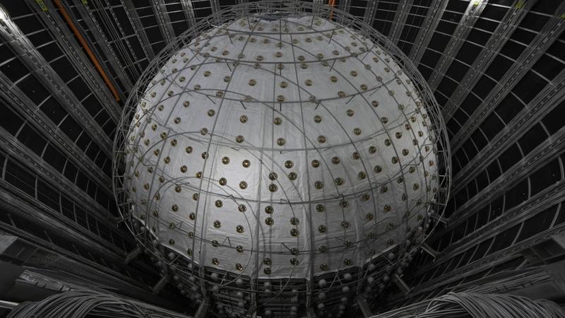  Underneath a granite hill in southern China, a massive detector is nearly complete that will sniff out the mysterious ghost particles lurking around us.