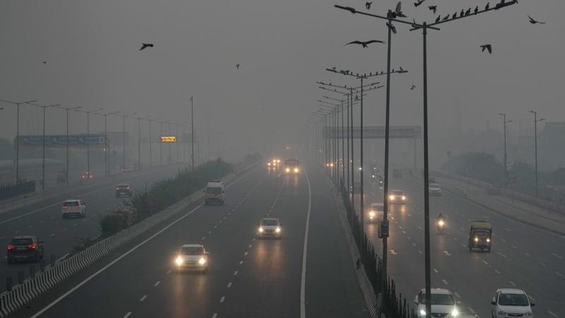 Vehicles move on a road amid low visibility due to smog, a day after Diwali festival celebrations, in New Delhi, early Friday morning,