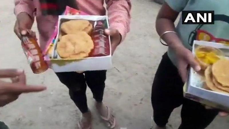 Liquor bottles kept inside food packets distributed at event organised by BJP leader Naresh Agarwal's son Nitin at a temple in Hardoi