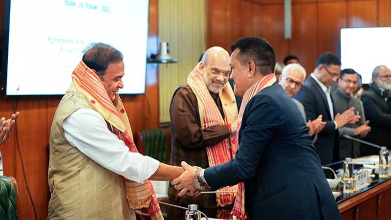 Union Home Minister Amit Shah and Assam Chief Minister Himanta Biswa Sarma with ULFA general secretary Anup Chetia during the signing of the peace accord. 