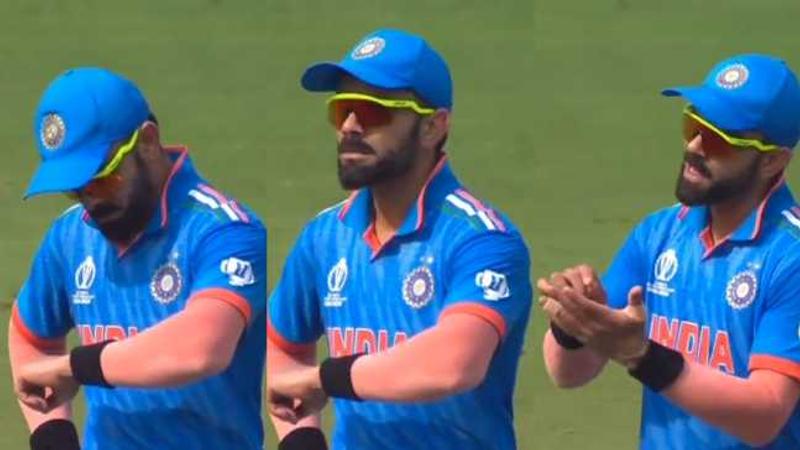 Virat Kohli looks at a fake watch on his wrist to mock Rizwan