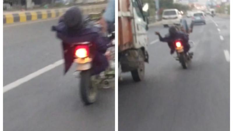 Man Drive Bike With His Legs While Using Phone