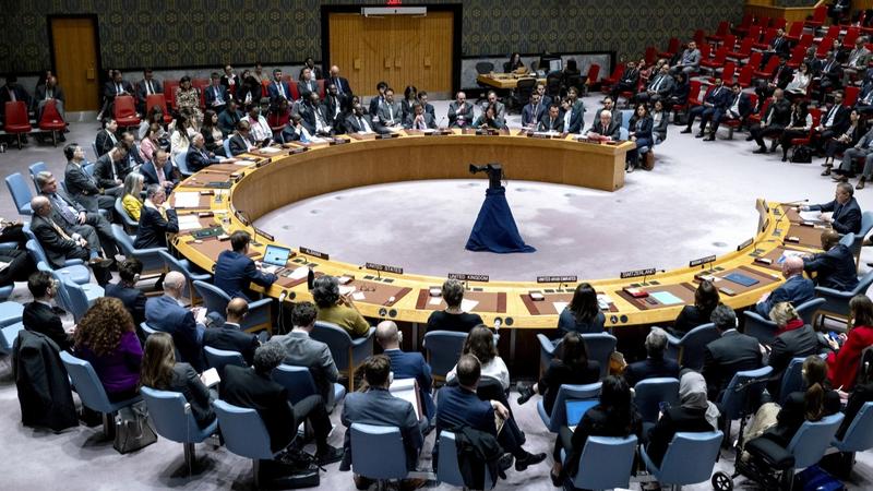 Palestinian U.N. ambassador Riyad Mansour, background right, addresses members of the U.N. Security Council at United Nations headquarters