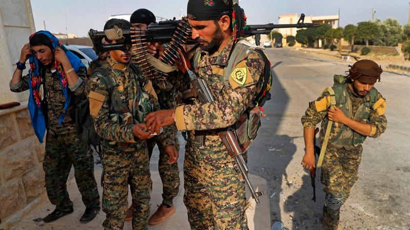 Members of the US-backed SDF preparing to fight Islamic State militants in Syria back in 2017. 