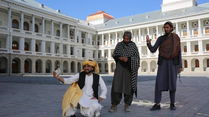 Afghans posing for selfies in front of the Darul Aman Palace in Kabul. 