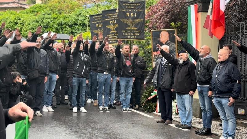 Dozens of people dressed in black raise their arms in a fascist salute to mark the 79th anniversary of Italian dictator Benito Mussolini's execution. 