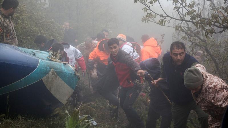 Rescue team members work at the scene of a crash of a helicopter carrying Iranian President Ebrahim Raisi in Varzaghan in northwestern Iran.