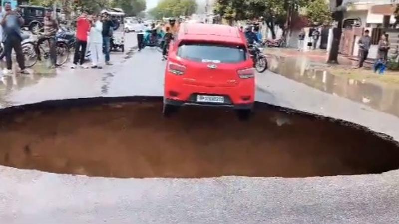 SHOCKING: Car Dangles on Edge of Masssive Crater After Road Collapses In Lucknow