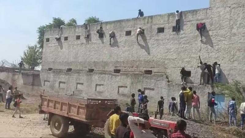 SHOCKING: People Climb School Walls to Pass Chits During Haryana Board Exams In Nuh | WATCH 
