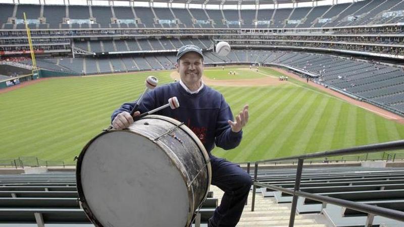 Cleveland Indians fan John Adams poses in his usual centerfield bleacher seat with his ever present bass drum