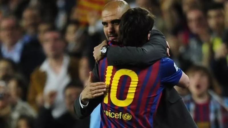 Pep Guardiola & Lionel Messi embracing each other