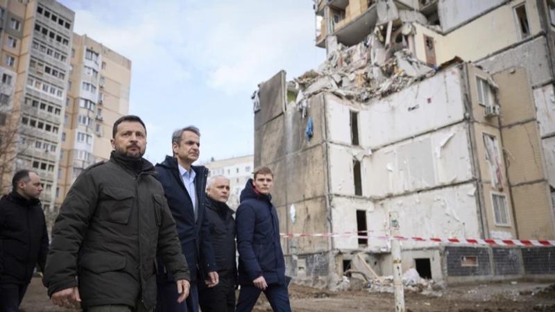 krainian President Volodymyr Zelenskyy, second from left, and Greece’s Prime Minister Kyriakos Mitsotakis, third from left, walk in a residential area damaged by Russian attack in Odesa