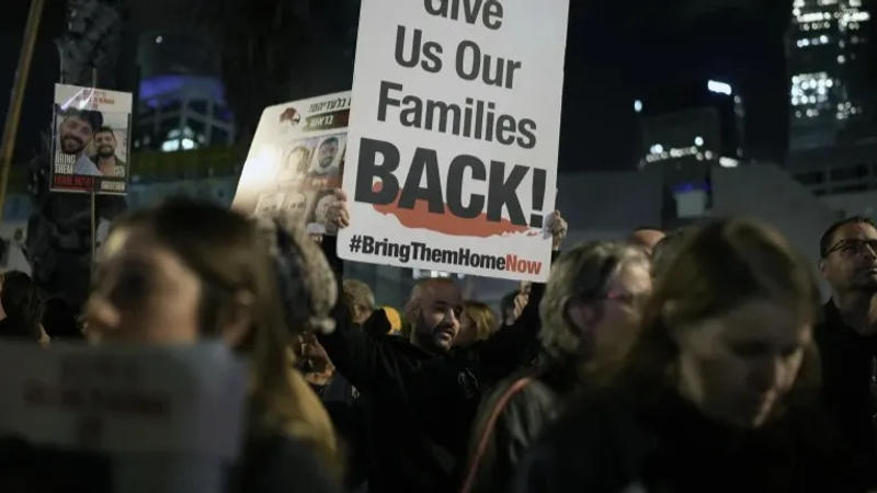  A man holds a sign calling for the release of the hostages taken by Hamas militants into the Gaza Strip during a demonstration at the Hostages Square in Tel Aviv, Israel