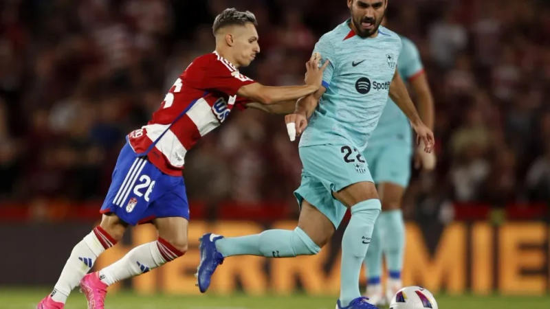 Granada’s Bryan Zaragoza pushes Barcelona’s Ilkay Gundogan during a Spanish La Liga soccer match