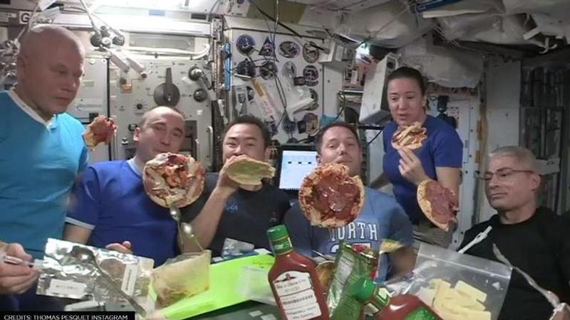 Astronaut enjoys pizza