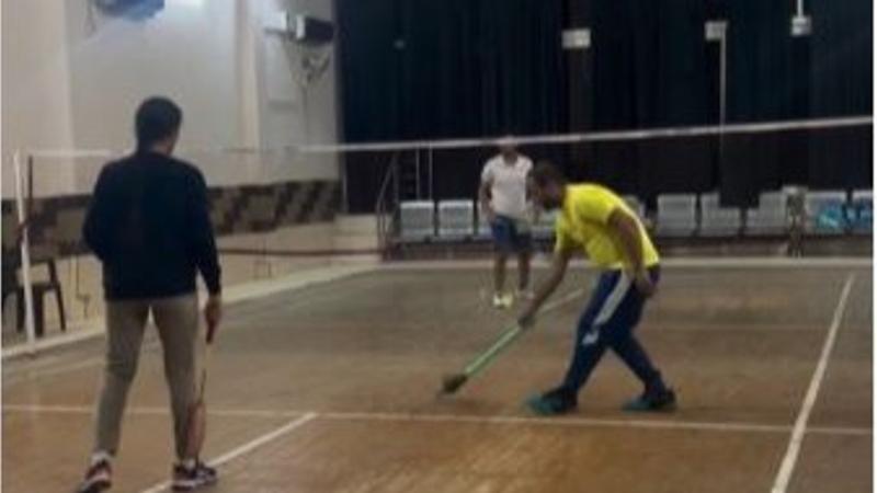 Man Playing Badminton With 'Jharu'