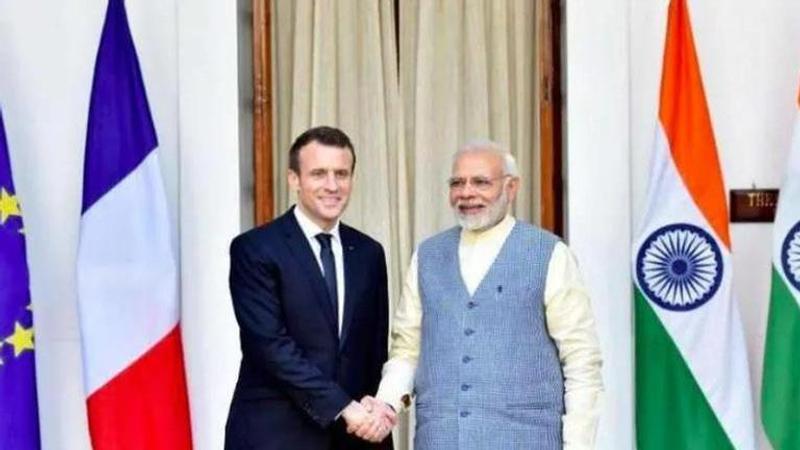 Prime Minister Narendra Modi shakes hand with France's President Emmanuel Macron. IMAGE: PTI