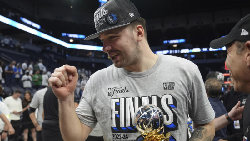 Luka Doncic with Magic Johnson trophy for being the Western Conference Finals MVP