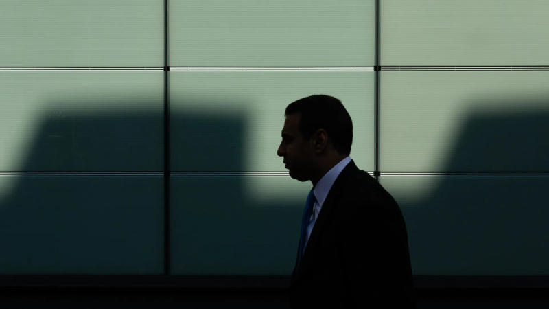 A corporate employee walking down the street