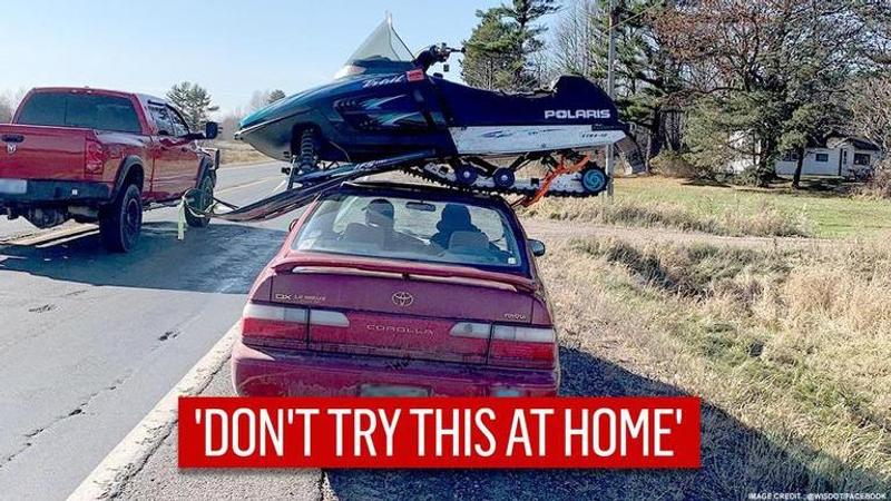 Photo of snowmobile strapped atop car surfaces, 'there's alcohol involved' quips internet