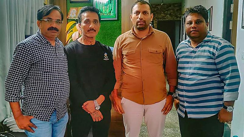 Mumbai Police Crime Branch personnel with Bhavish Bhinde (in black) after arresting him in connection the billboard collapse.