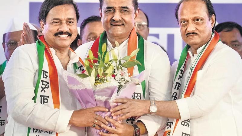 Maharashtra Deputy Chief Minister Ajit Pawar (R) with NCP leaders Praful Patel (C) and Sunil Tatkare (L) during a meeting in Mumbai 