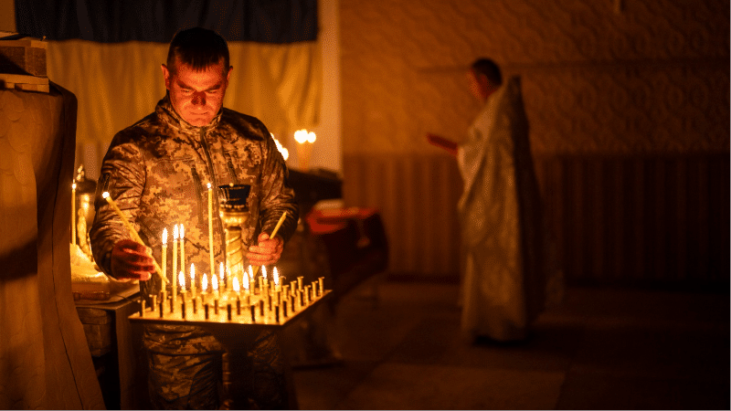 A Ukrainian serviceman of the 72nd Separate Mechanized Brigade, lights candles during a Christian Orthodox Easter religious service, in Donetsk region, Ukraine, Saturday, May 4, 2024.