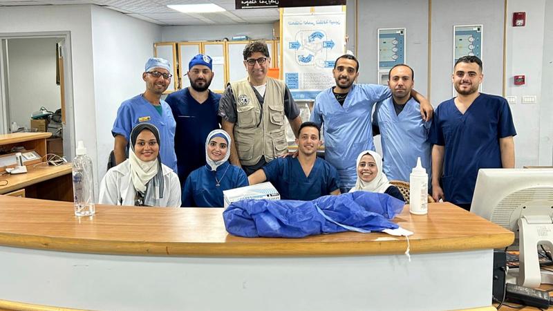 Dr. Ammar Ghanem, an ICU specialist from Detroit volunteering with the Syrian American Medical Society, third from left, poses with a local team of ICU nurses and staff at the European General Hospital on May 6 in Khan Younis, Gaza.