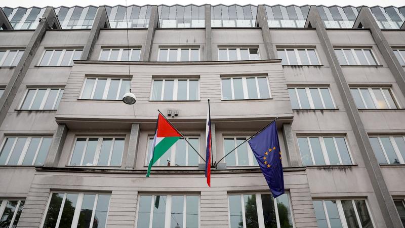 A Palestinian flag flies next to a Slovenian, center, and a European Union flag, right, at the government building in Ljubljana, Slovenia, May 30, 2024.