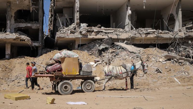 Palestinians salvage items from the destruction in the wake of an Israeli air and ground offensive in Jebaliya, northern Gaza Strip after Israeli forces withdrew from the area, May 31, 2024. 