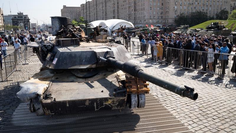 Representatives of the diplomatic corps look at U.S.-made M1 Abrams tank, and other U.S. military vehicles, hit and captured by Russian troops during the fighting in Ukraine as they visit an exhibition of Western military equipment seized from Ukrainian forces, in Moscow, on May 31, 2024.